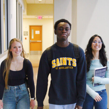 Three students walking in the St. Scholastica Science Center.