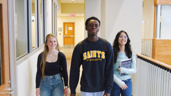 Three students walking in the St. Scholastica Science Center.