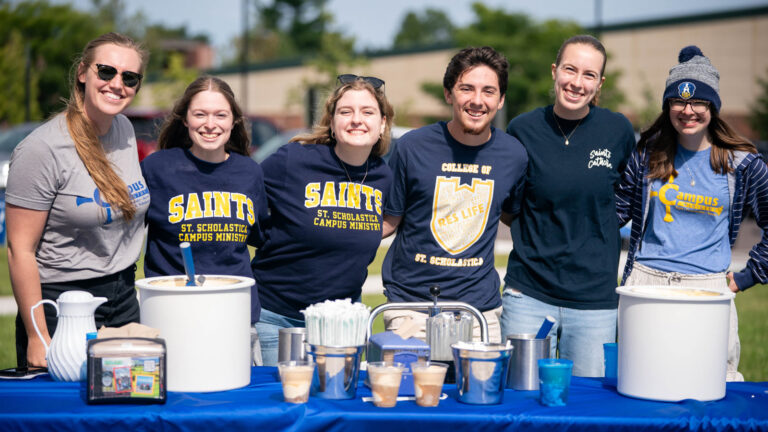 A small group of St. Scholastica students serving root beer floats.
