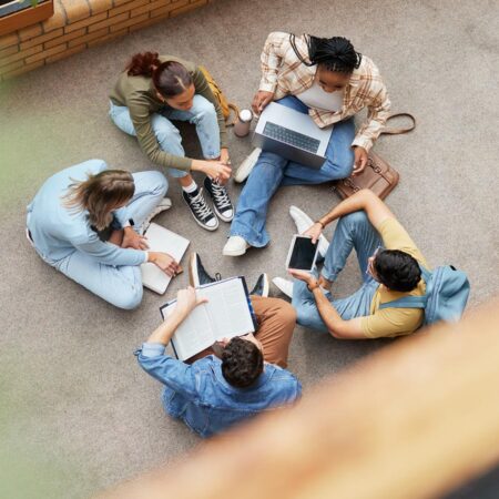 An overhead view of a group of students studying together in a courtyard.