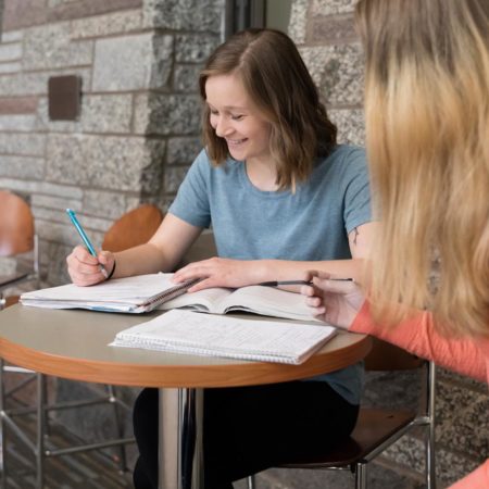 Two students studying in the Benedictine Commons at St. Scholastica.