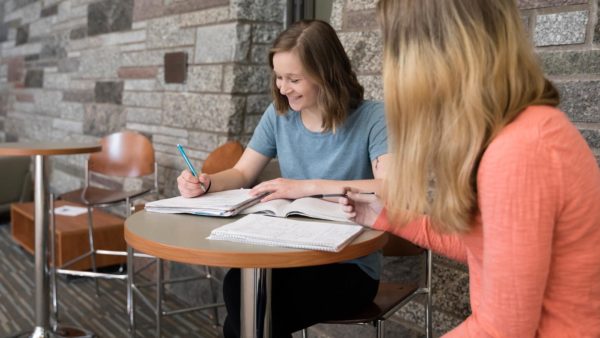 Two transfer students studying in the Benedictine Commons at St. Scholastica.