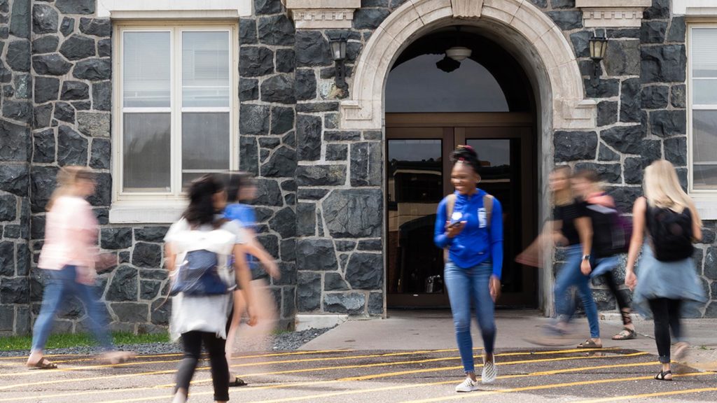 St. Scholastica students walking in front of Tower Hall.