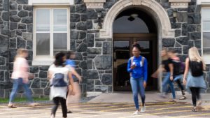 St. Scholastica students walking in front of Tower Hall.