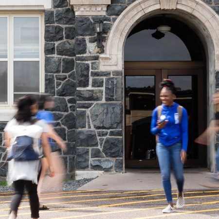 St. Scholastica students walking in front of Tower Hall.