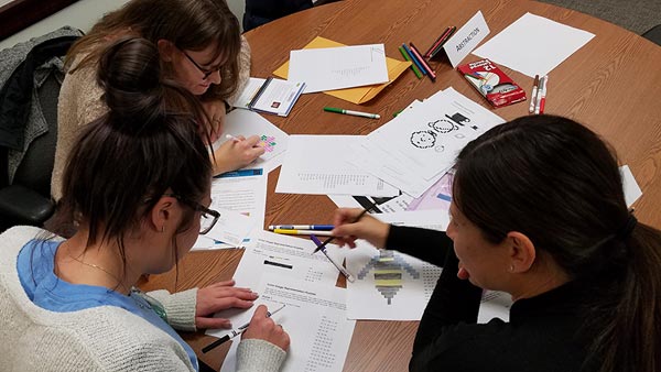 Teacher working with students in a classroom.