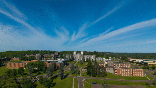Tower Hall and Duluth main campus from a drone perspective. Bright blue skies.