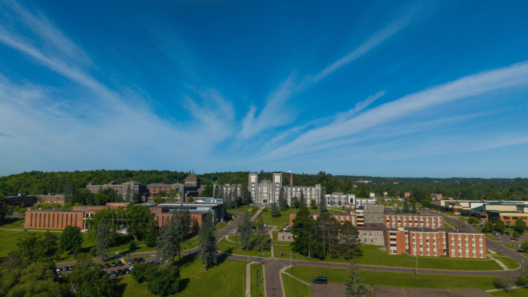 Tower Hall and Duluth main campus from a drone perspective. Bright blue skies.