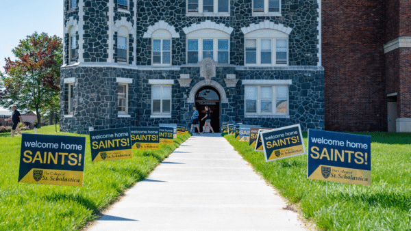 "Welcome home, Saints" signs line the sidewalk outside of Tower Hall.