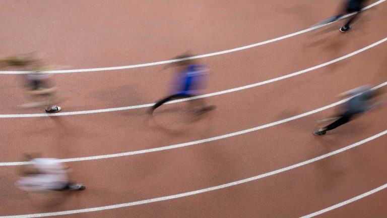 St. Scholastica students running on the lower track in the Burns Wellness Commons (BWC).