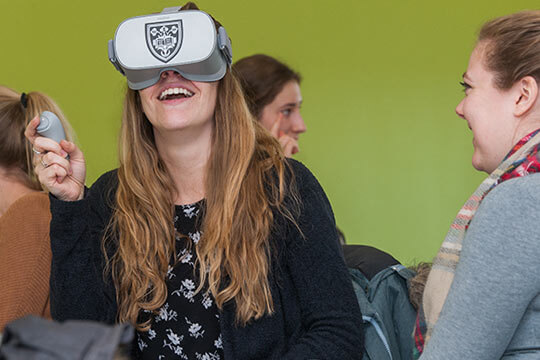 PA student Samantha Lahr uses a handheld device to navigate her VR experience