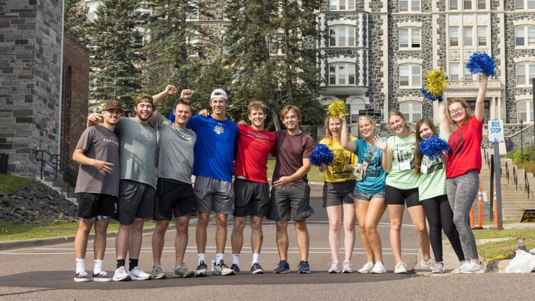 Photo of students in front of tower hall.